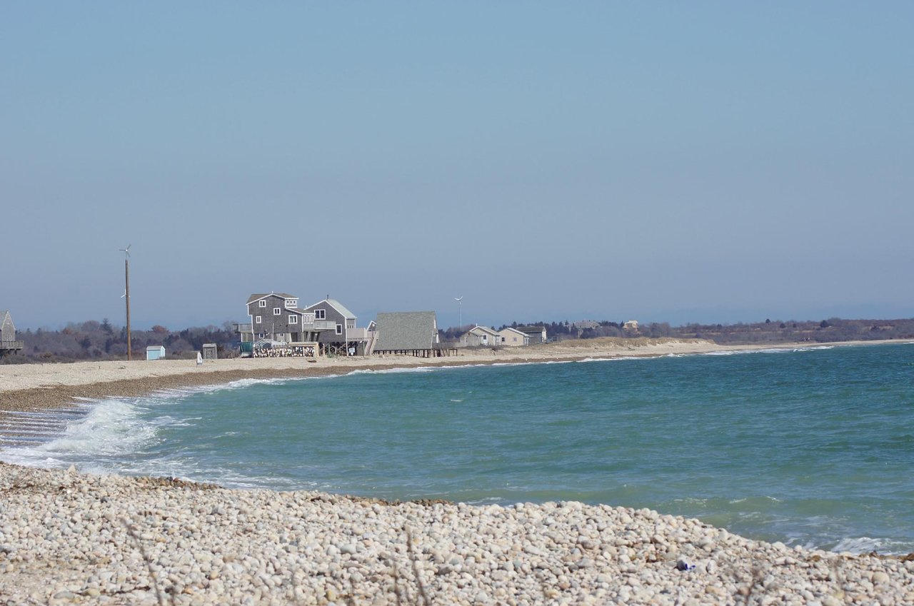 Stilt cottages line the pebbly shore of East Beach in Westport.