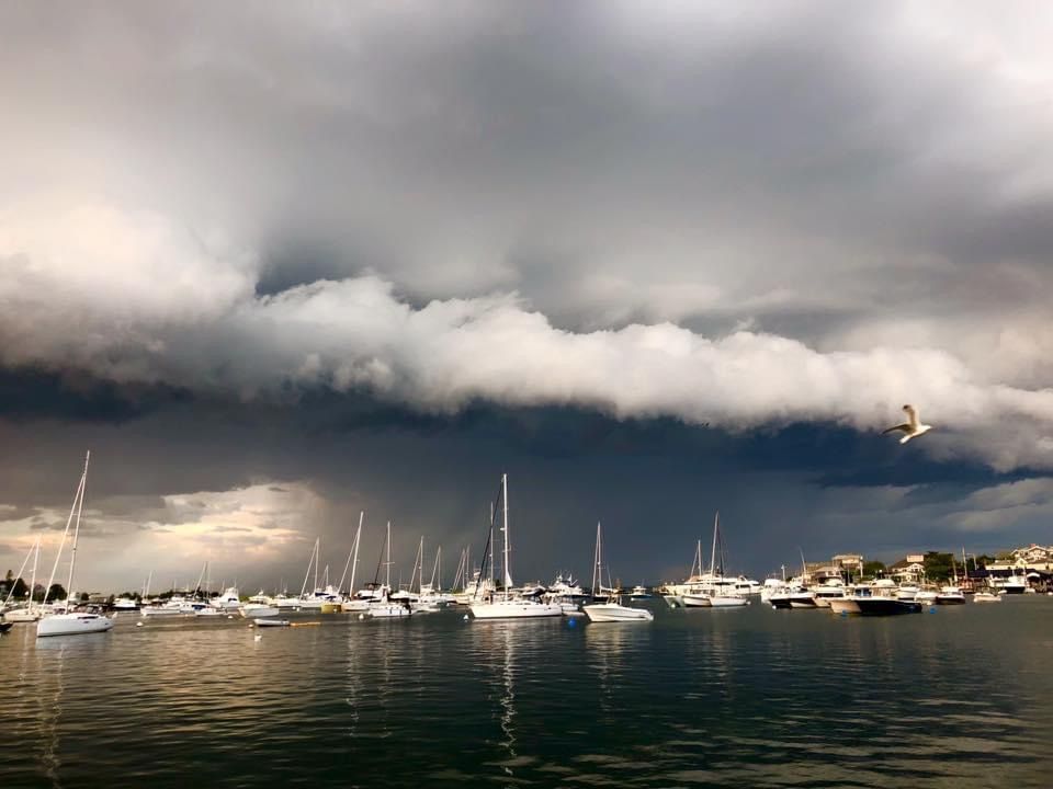 Dramatic storm clouds roll over moored boats in the harbor at South Dartmouth.